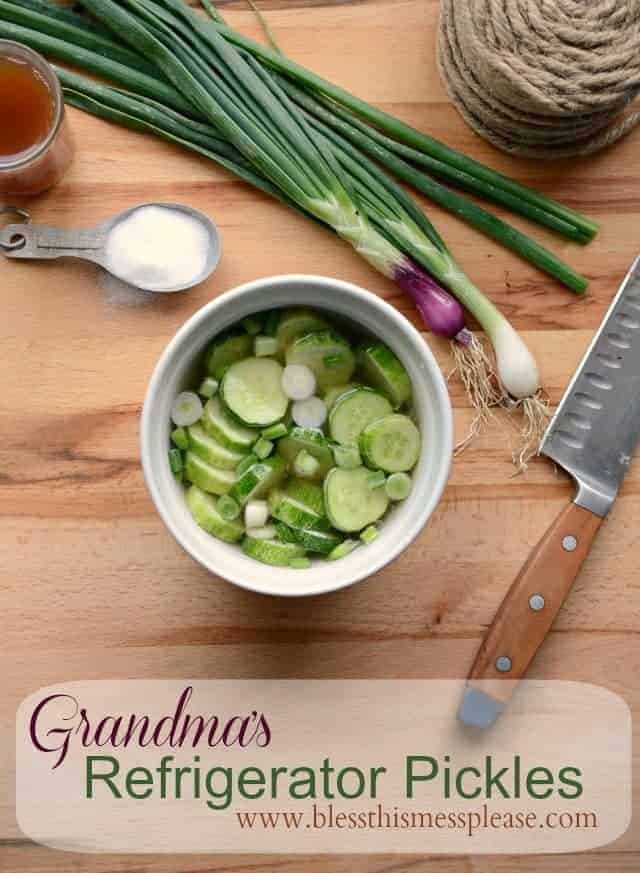 Quick Pickled Cucumbers like my grandma makes every summer from www.blessthismessplease.com Quick and easy pickled cucumbers with onion a measuring spoon full of sugar and a knife on wooden surface.
