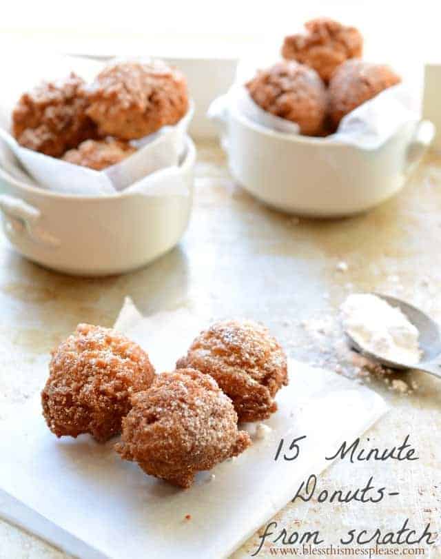 donut holes in a small dish sprinkled with powdered sugar