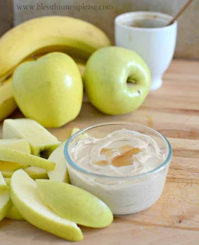 3 Ingredient Healthy Fruit Dip just PB, honey, and greek yogurt - easy and so tasty! from www.blessthismessplease.com a small glass bowl of fruit dip with sliced apples and a banana sitting to the side