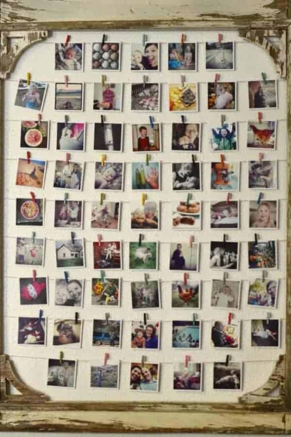 Rustic wooden frame with strings and mini clips holding up rows of square photos