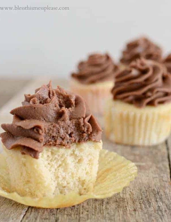 Perfect vanilla cupcakes topped with  homemade whipped milk chocolate frosting are what dreams are made of.