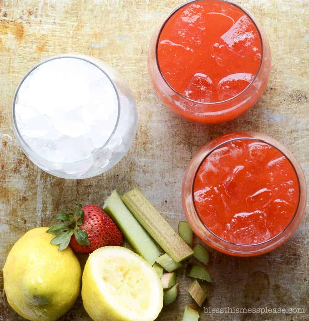 Strawberry Rhubarb Lemonade in a glass with a glass of ice