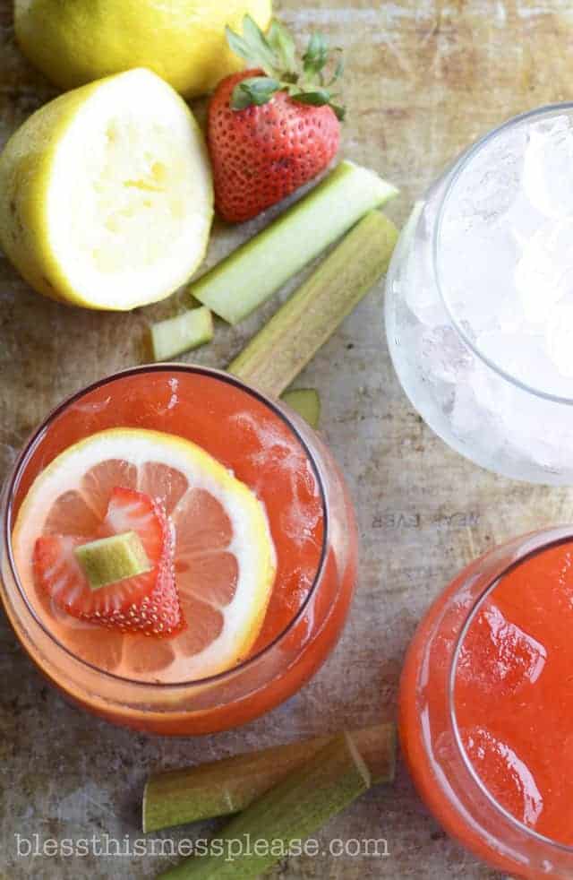 Strawberry Rhubarb Lemonade with ice and a lemon and strawberry slice in it