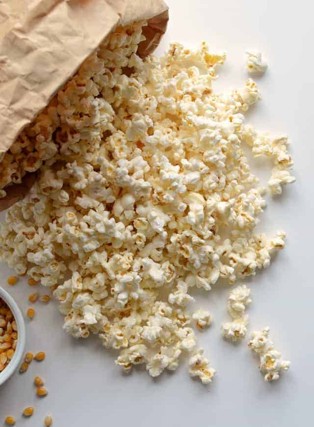 Quick and easy guide on how to pop popcorn in the microwave using just a paper bag, no oil needed. 
