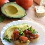 Image of avocado bruschetta with half an avocado