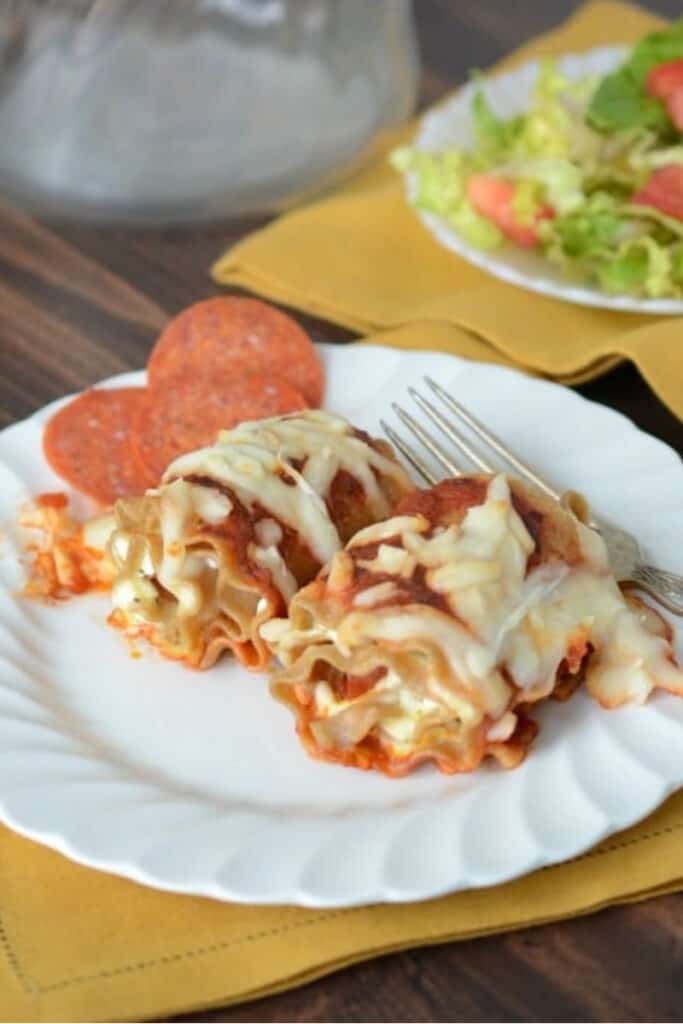 lasagna with cheese and pepperoni on a white plate