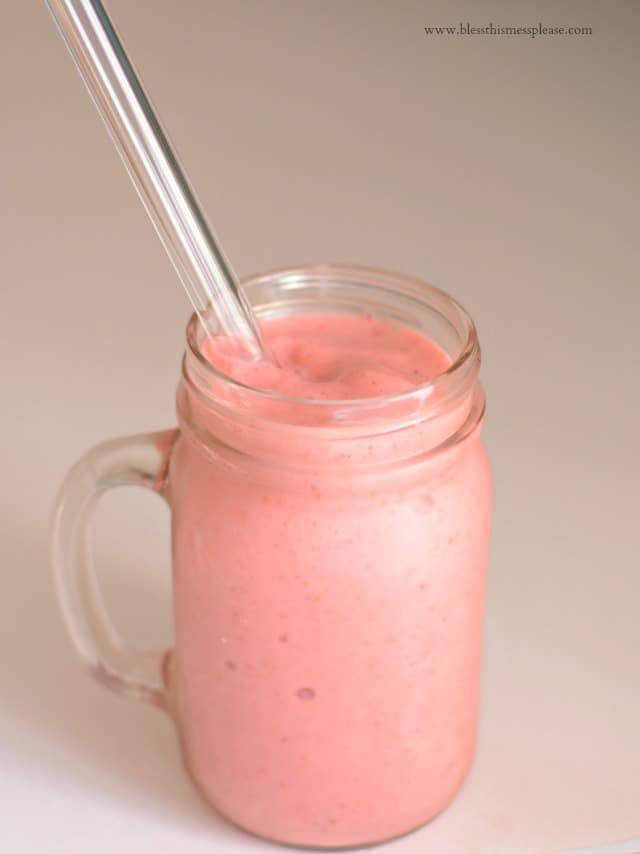 Guilt Free Strawberry Milkshake in a glass jar with a large straw inserted