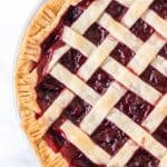 half view of the complete cherry pie with a lattice crust