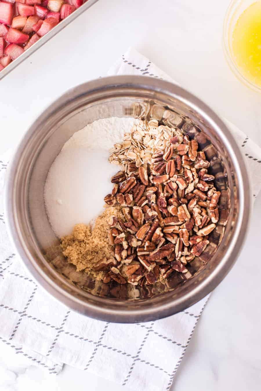 mixing bowl with chopped pecans brown sugar and oats