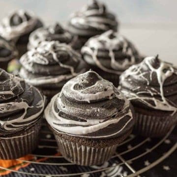 spiderweb Halloween cupcakes on a wire rack