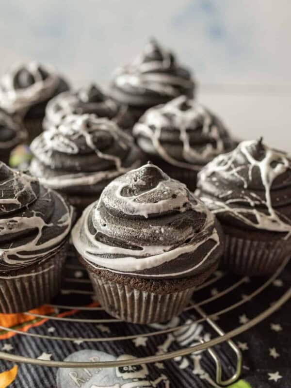 spiderweb Halloween cupcakes on a wire rack