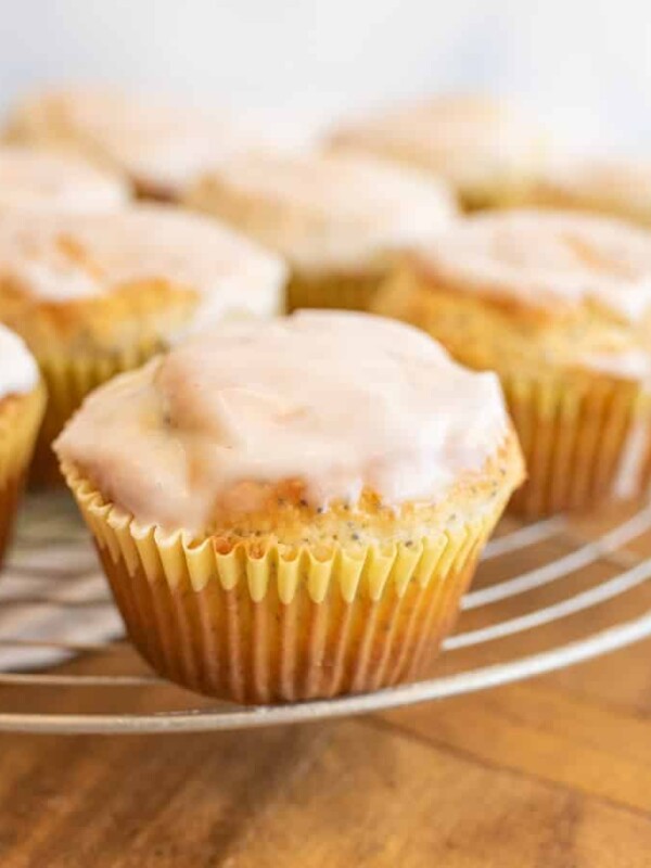 close up picture of lemon poppy seed muffins on a rack