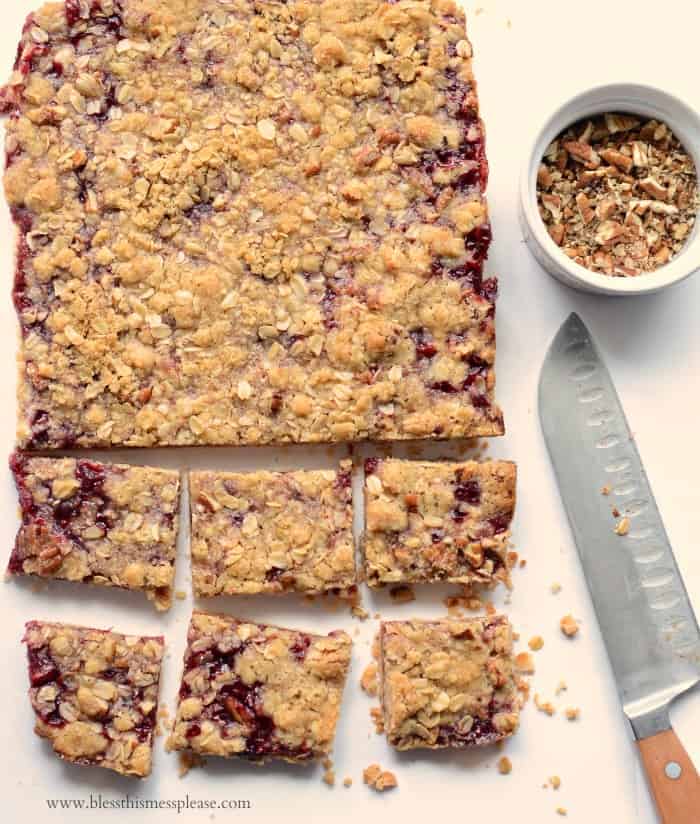 America's Test Kitchen's Raspberry Streusel Bars being cut into squares