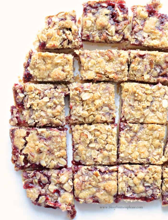 A batch of raspberry bars with streusel topping cut into squares