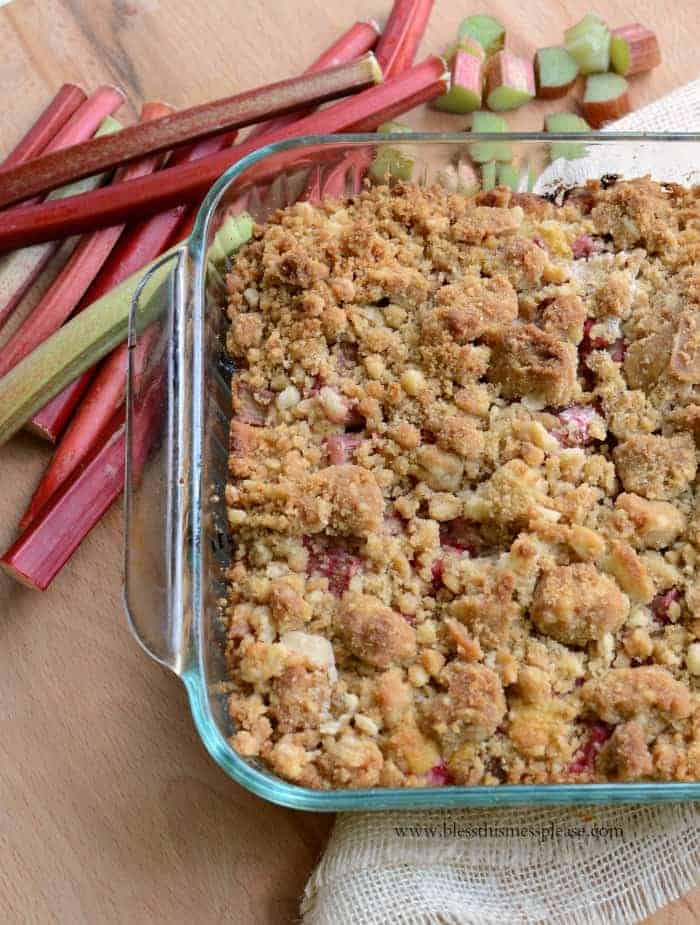 Rhubarb Crumb Bars in a glass pan resting on white towel