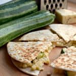 quesadilla with corn and chopped zucchini next to whole zucchini