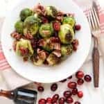 Plate of roasted brussels sprouts with cranberries, bacon and maple syrup