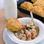 Bowl of chicken pot pie and biscuit