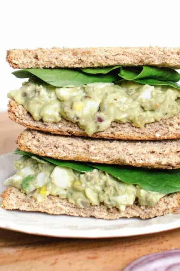 Avocado Egg Salad sandwiches stacked on a plate