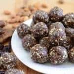 healthy cherry energy balls stacked on a white plate