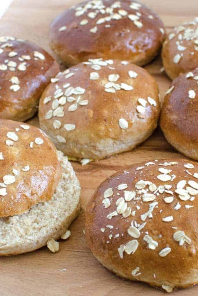 wheat and oat buns on a wood board