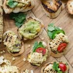 photo of bruschetta toast with guacamole and roasted corn on top