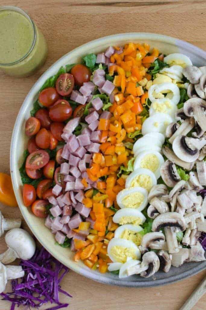 a bowl of ingredients for a rainbow salad with eggs and mushrooms