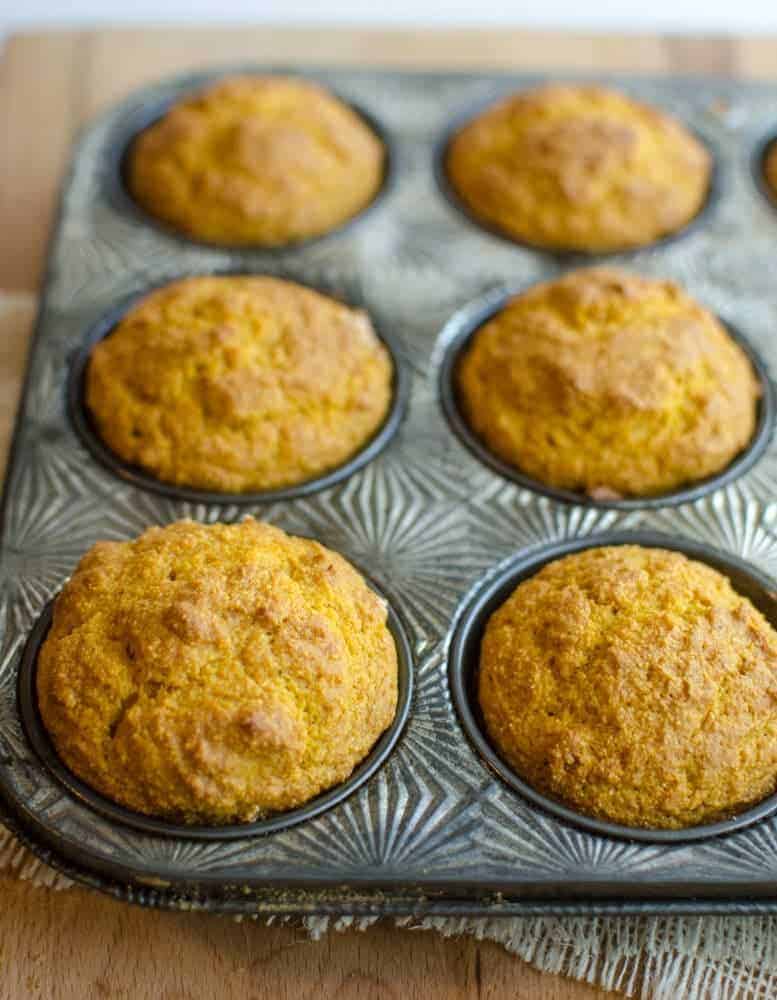 fluffy pumpkin cornbread muffins in a muffin tin