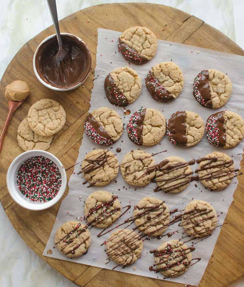 A dip in chocolate and some festive sprinkles turn year-round favorite peanut butter cookies into a delicious Christmas treat. A dip in chocolate and some festive sprinkles turn year-round favorite peanut butter cookies into a delicious Christmas treat.