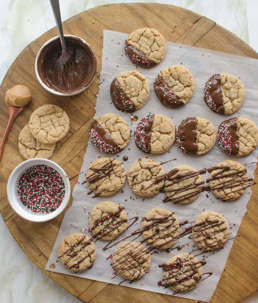 A dip in chocolate and some festive sprinkles turn year-round favorite peanut butter cookies into a delicious Christmas treat.