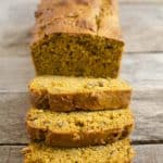 pumpkin bread loaf close up as its sliced ¾ of the way down