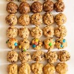 all 8 kinds of oatmeal energy balls all lined up in a 5 by 8 pattern on a white board.