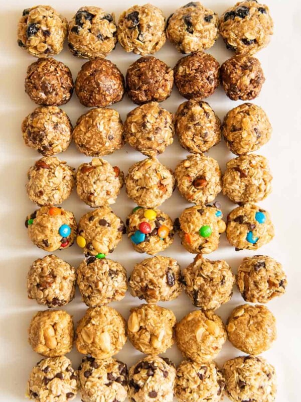 all 8 kinds of oatmeal energy bites all lined up in a 5 by 8 pattern on a white board