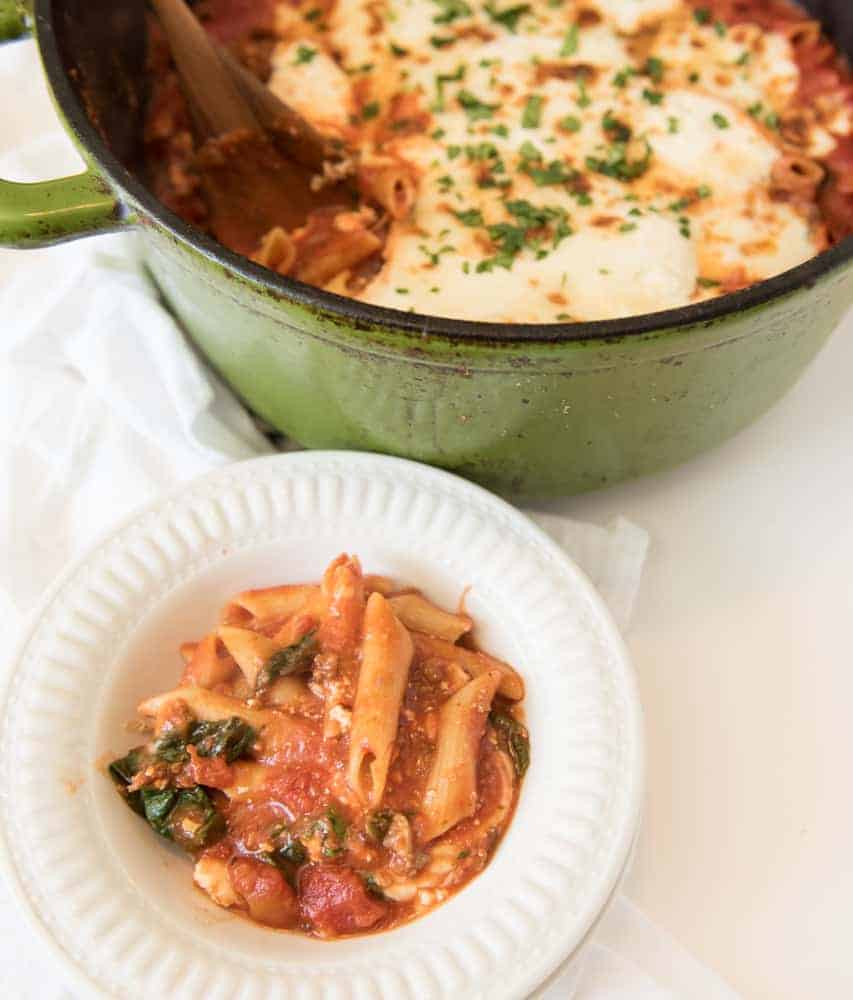 The best cheesy One Pot Baked Ziti recipe with sausage and spinach; everything, including the noodles are cooked in one pot and then finished in the oven.