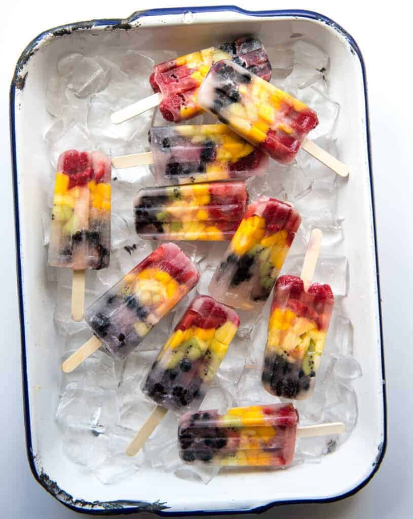 Rainbow popsicles are naturally sweet, loaded with real fruit,  and so simple to make that your kids can almost make them by themselves!