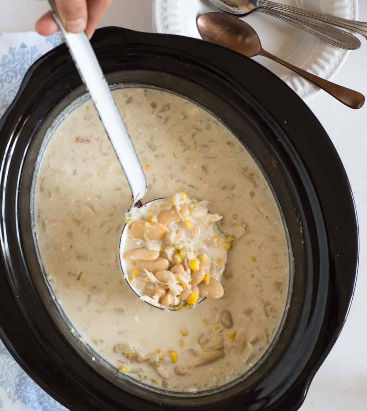 The best creamy slow cooker white chicken chili on the block. This recipes is super easy to make, cooks by itself, and is a chili cook off winning recipe.