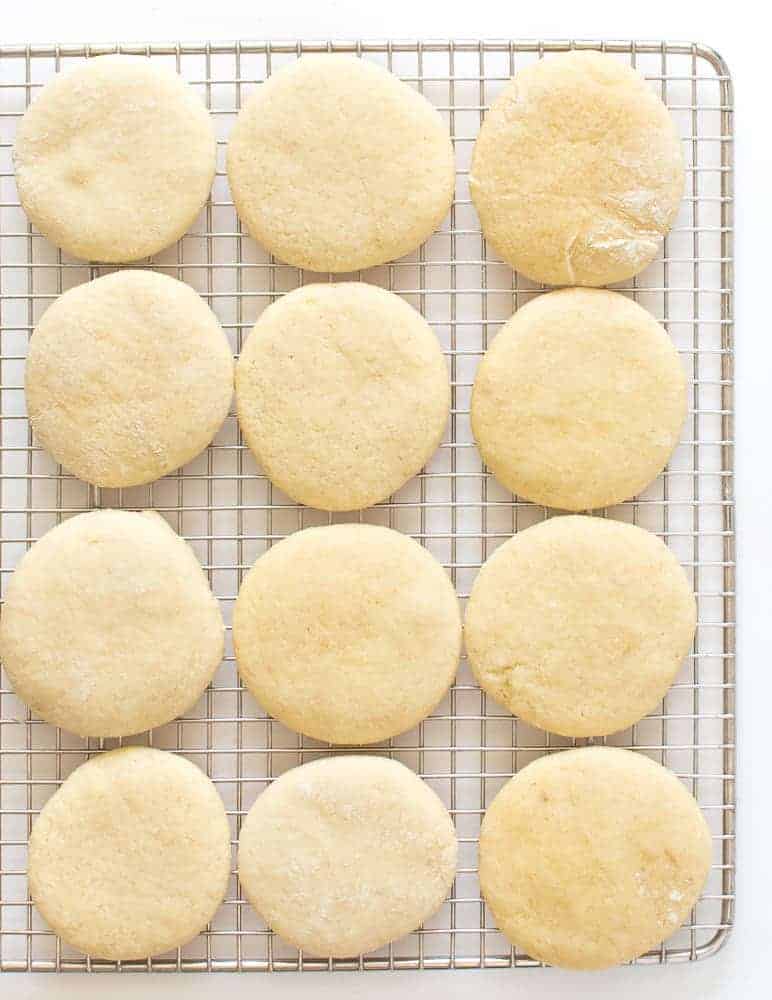 pale round cookies on a silver wire rack.