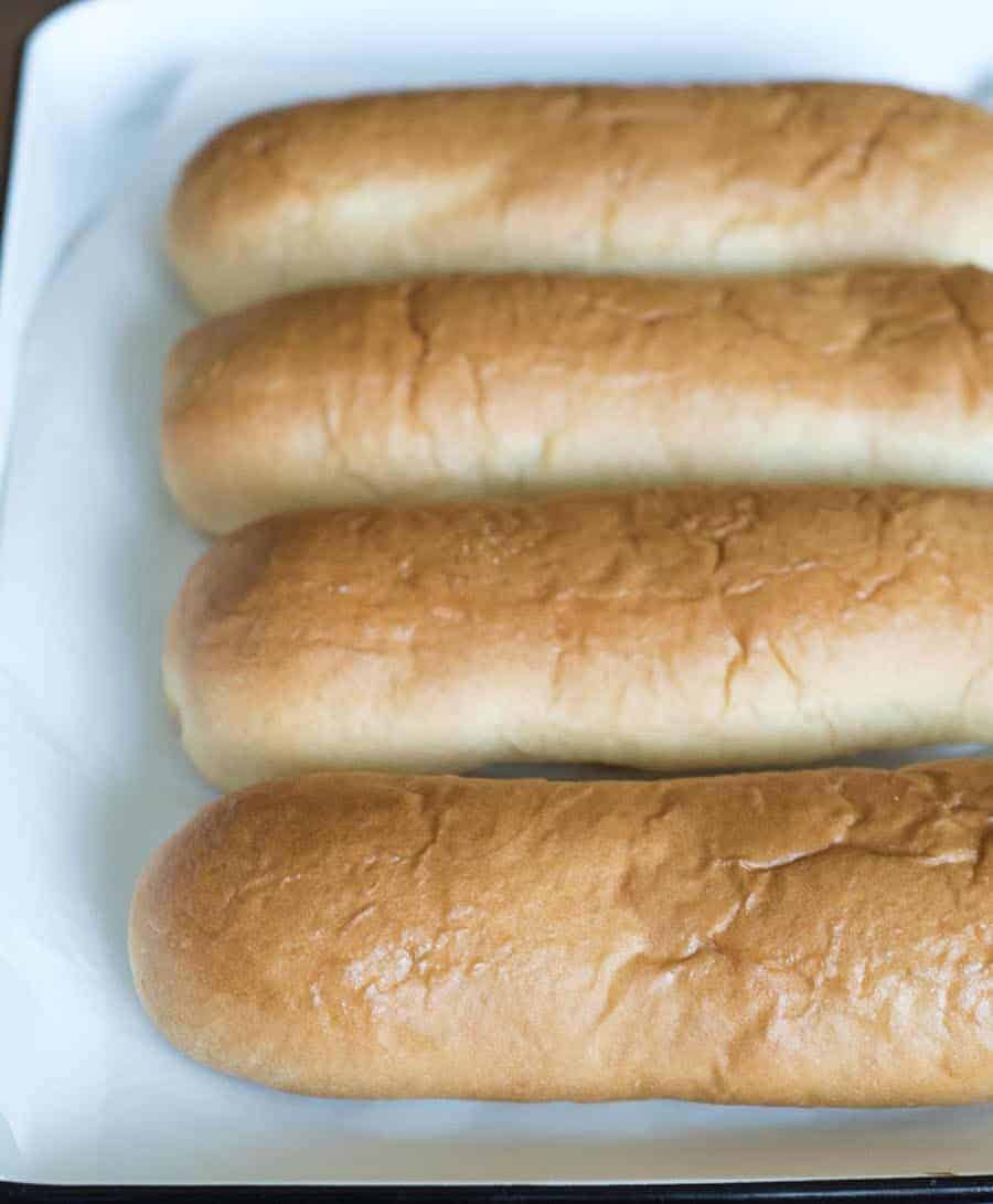 four baked long loaves of bread with a golden crust.