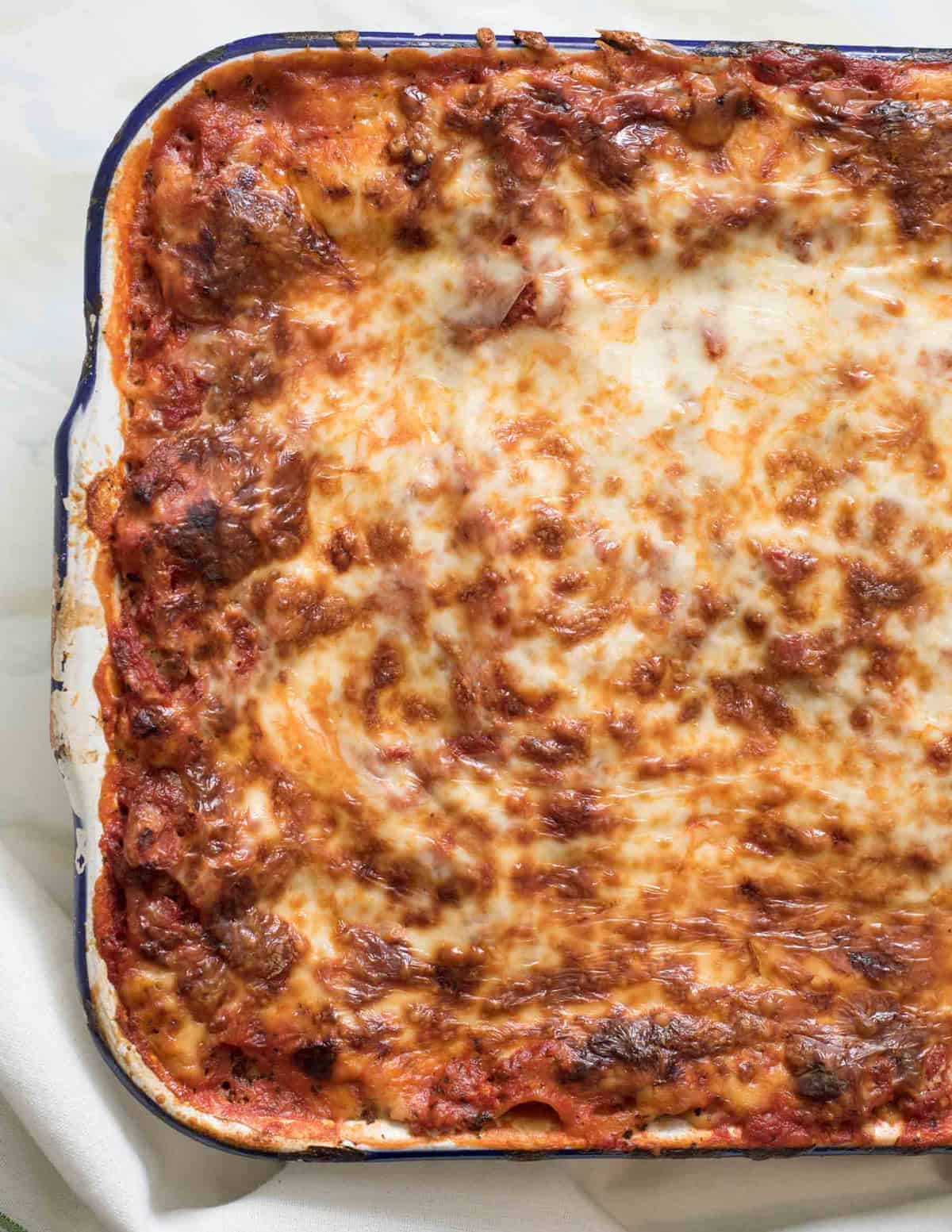 Classic lasagna recipe made with traditional ingredients like sausage, homemade sauce, and loads of cheese. Plus it's freezer friendly too.