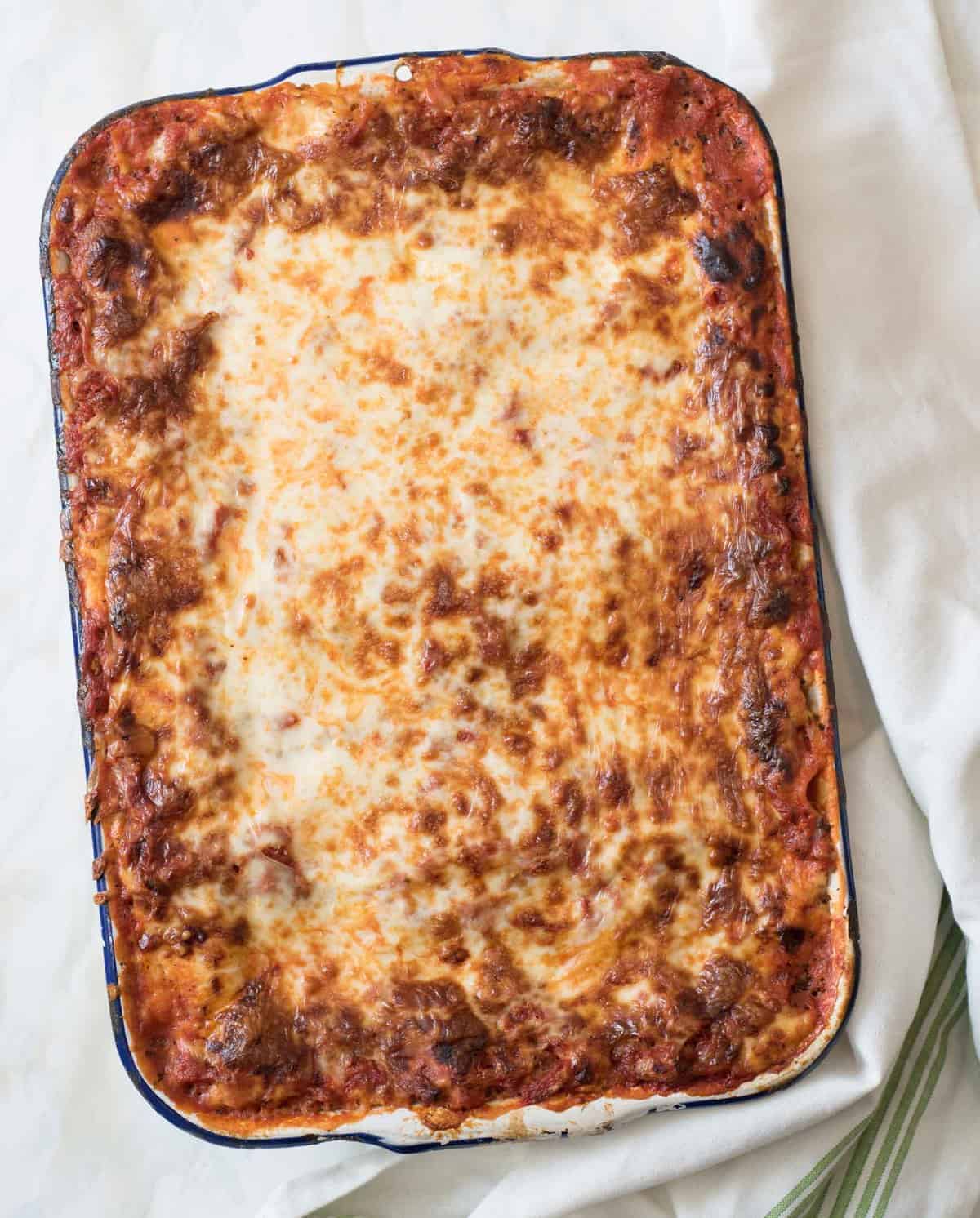 Classic lasagna recipe made with traditional ingredients like sausage, homemade sauce, and loads of cheese. Plus it's freezer friendly too.