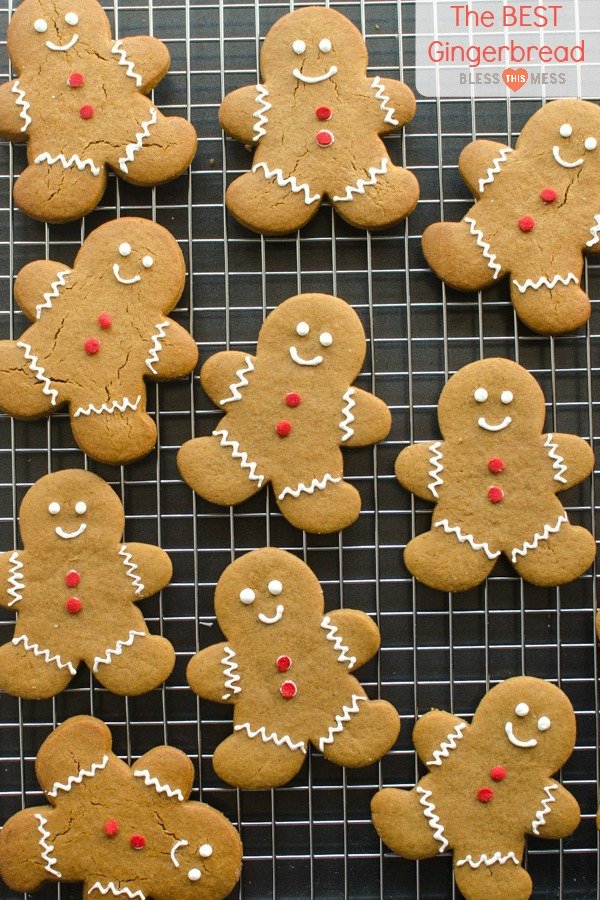 golden brown molasses gingerbread men cookies on black tray