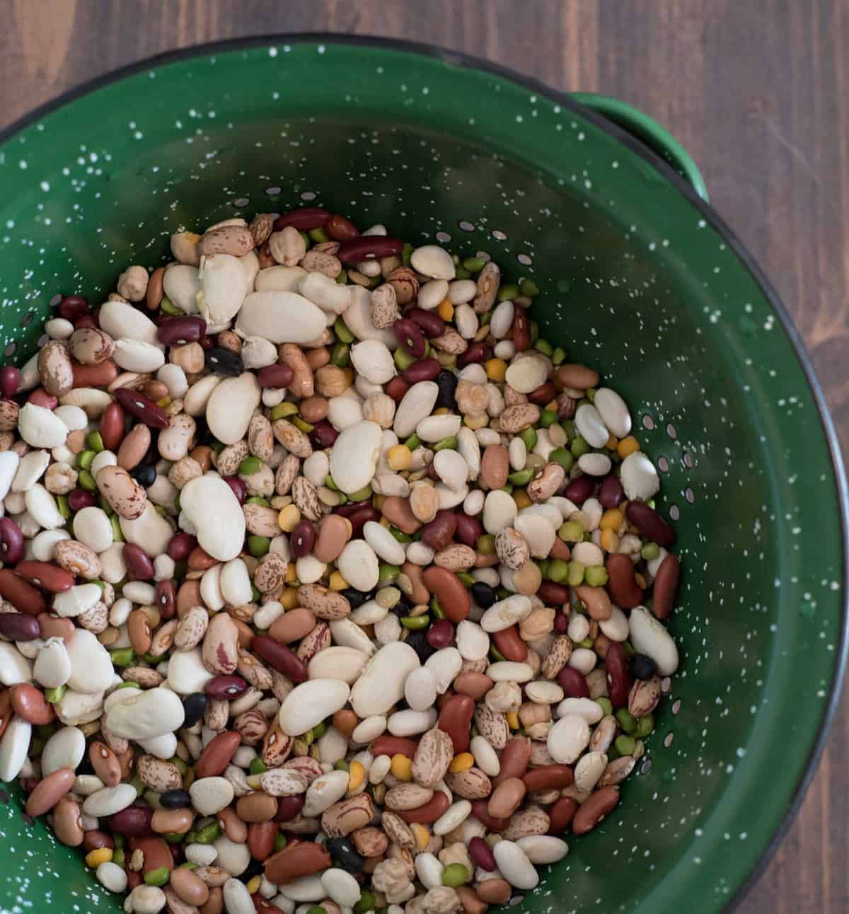 cajun bean mix in a green metal strainer