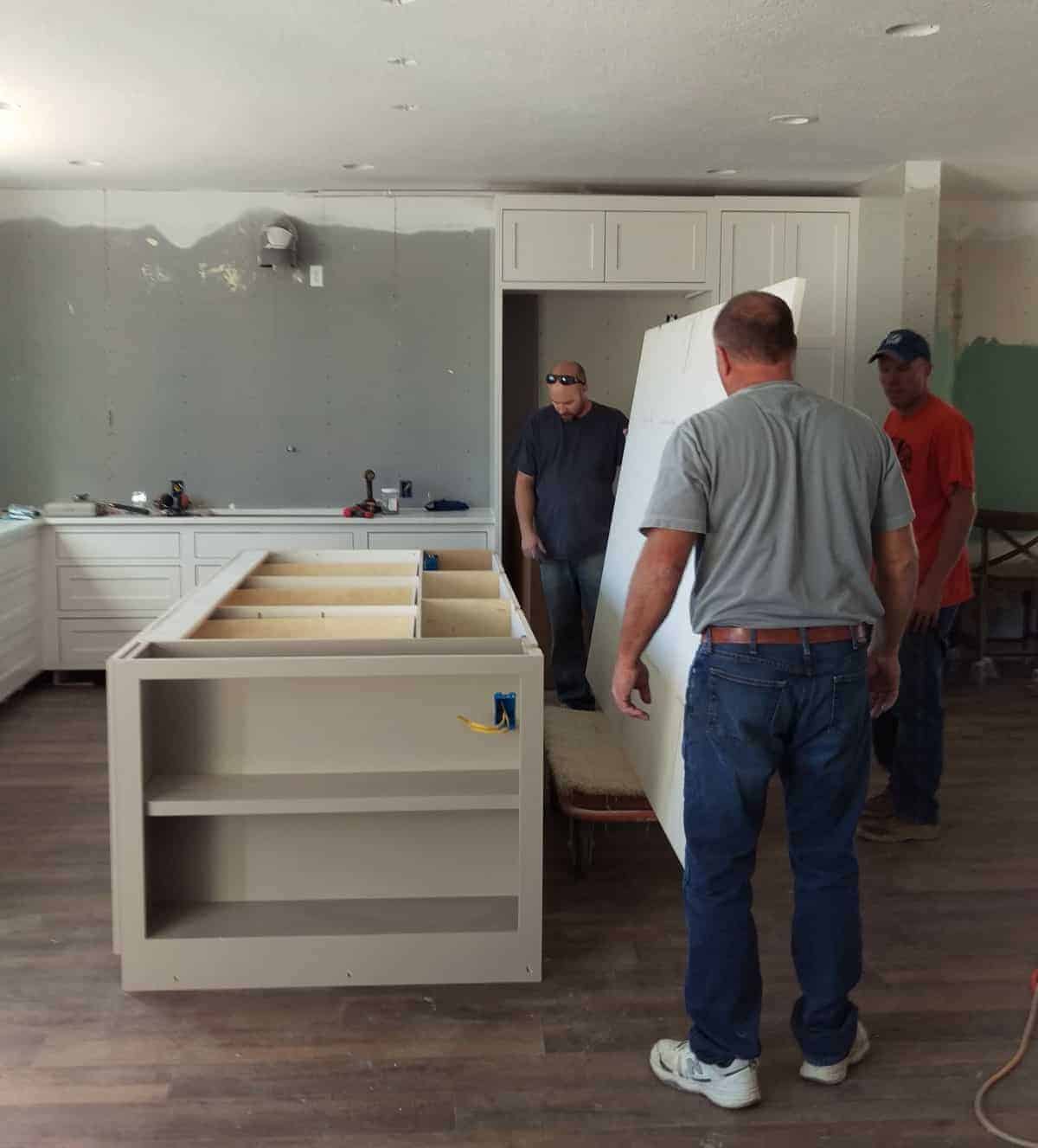 a large marble countertop being installed on the island in the kitchen