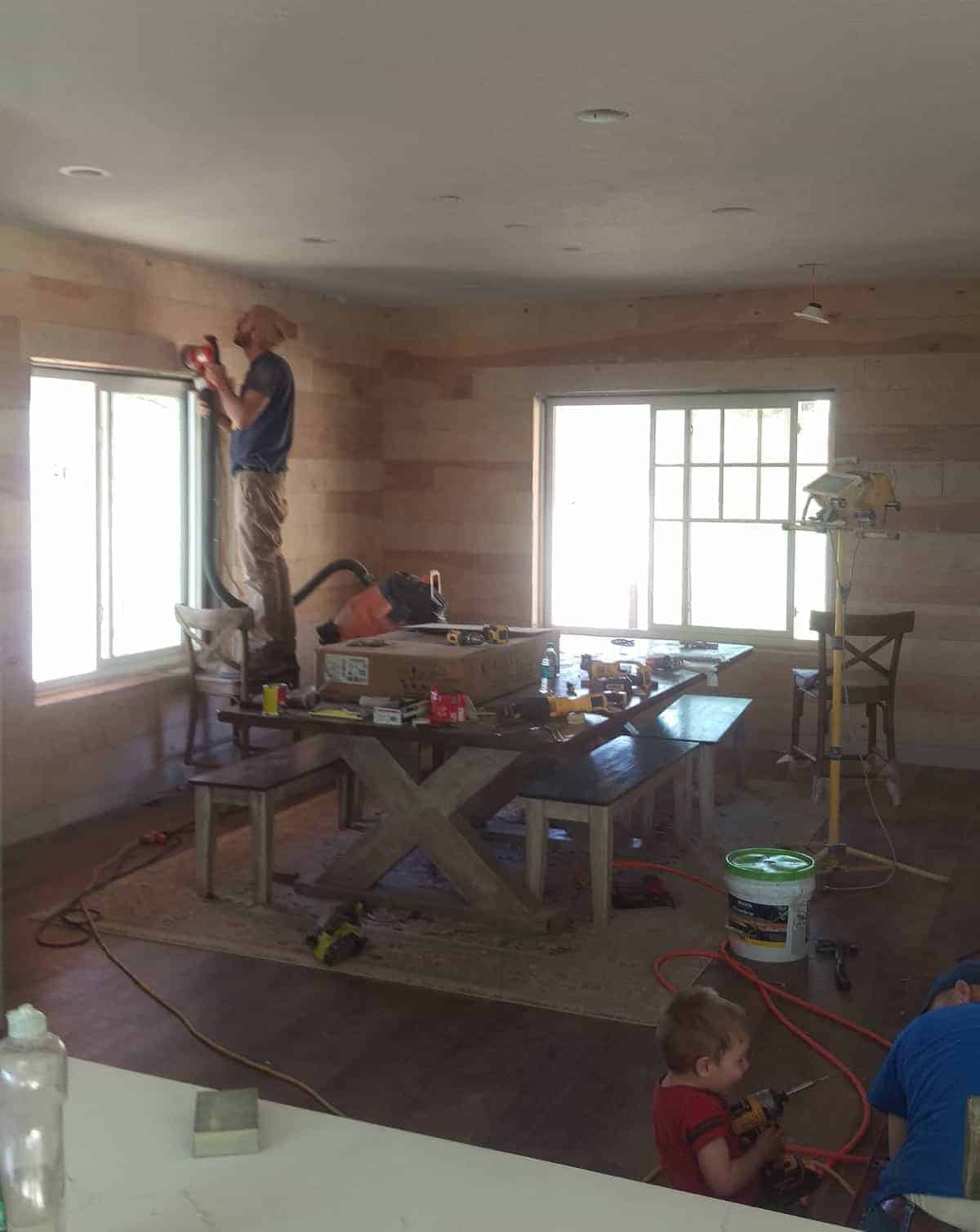 shiplap wood being installed on the dining room walls