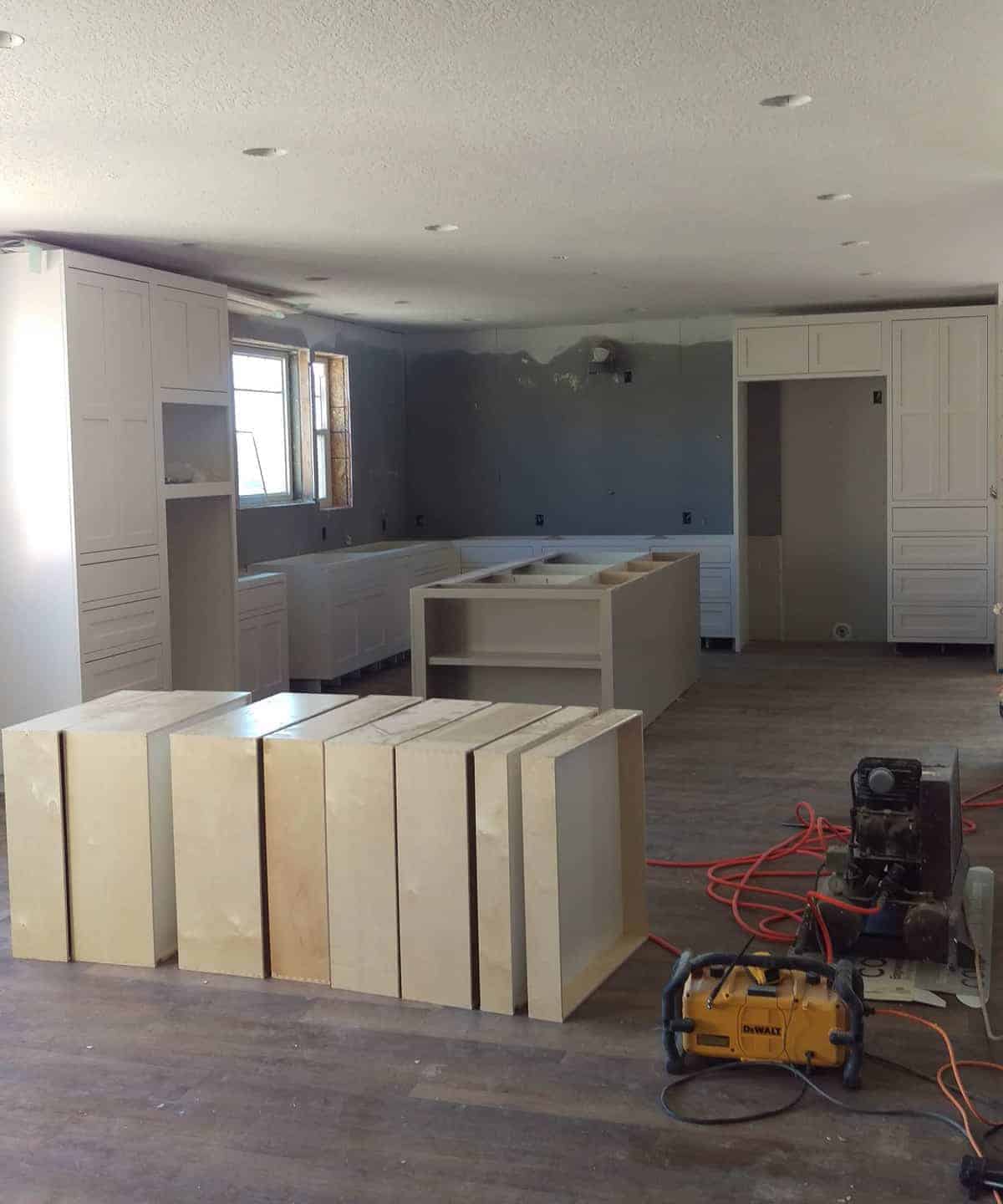 cabinets and an island being installed into the kitchen