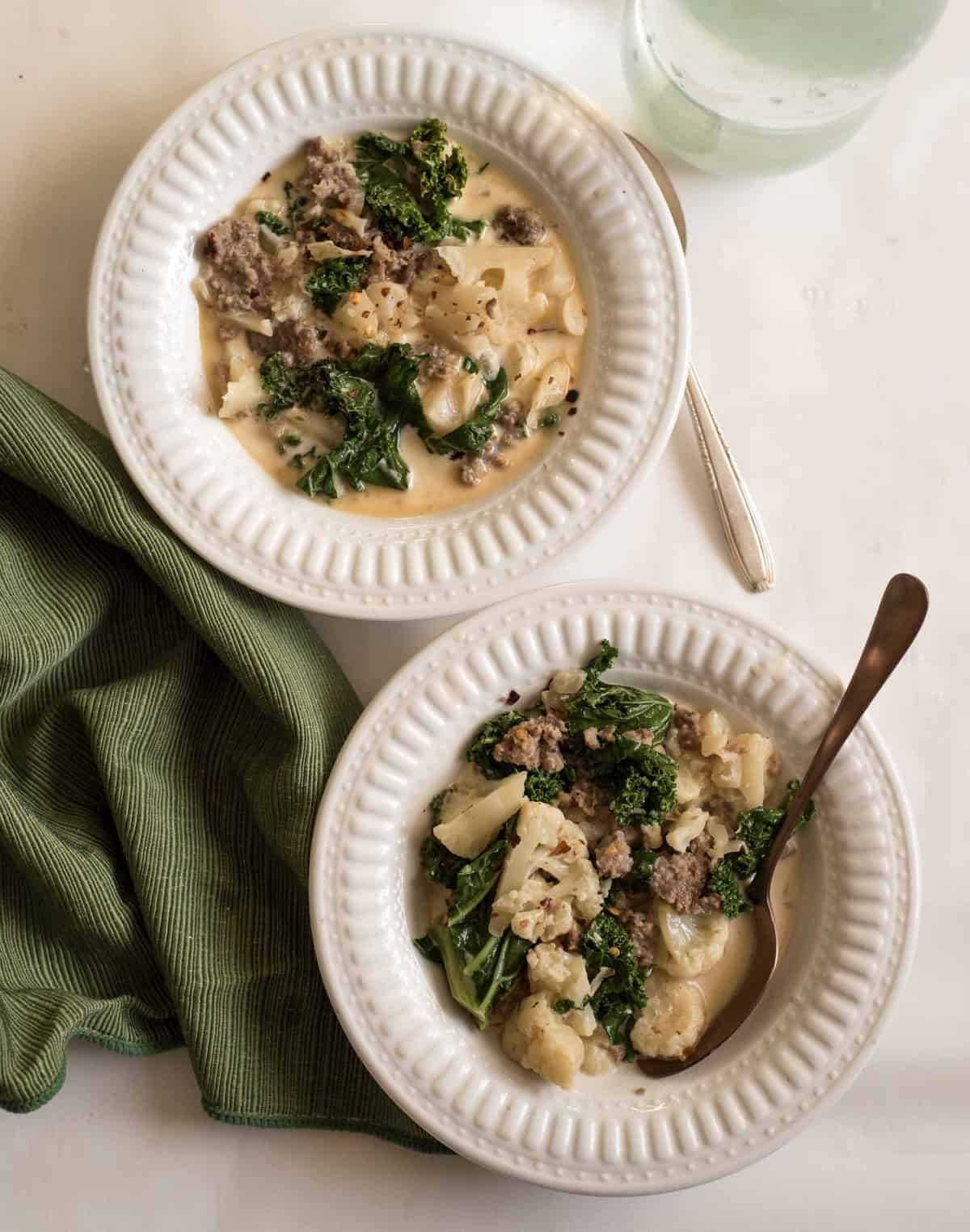 Healthy Cauliflower Sausage and Kale soup is the low carb version of Zuppa Toscana that uses cauliflower in place of the potatoes!