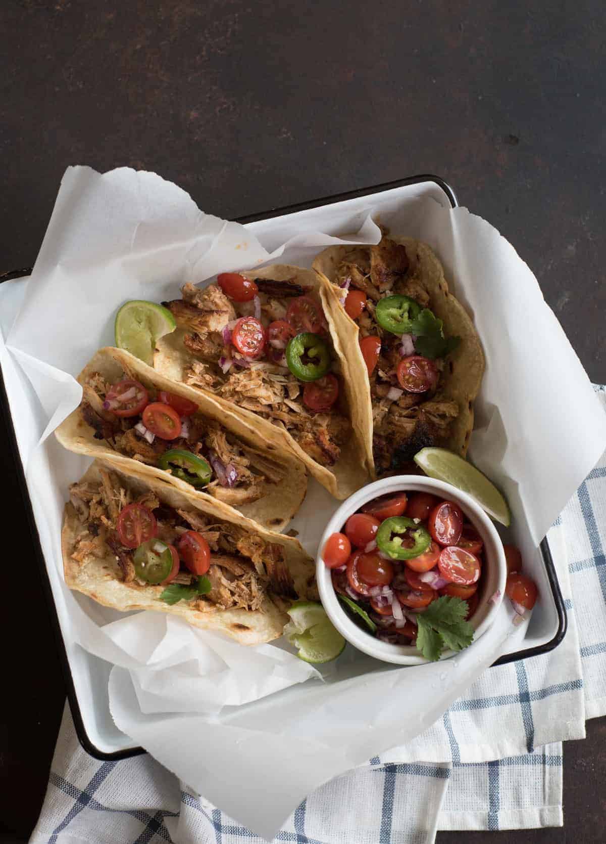 The best Instant Pot pork taco recipe on the internet. The secret is a whole lot of seasoning cooked into the pork and then finishing the dish under the broiler in your oven.