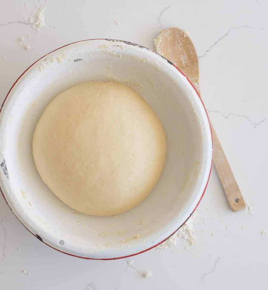 yeast dinner roll dough in a bowl before rising
