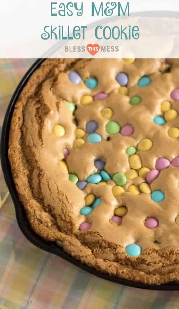 Warm and gooey skillet cookie recipe made with butter and brown sugar and topped with M&M's and perfect with a scoop of ice cream.