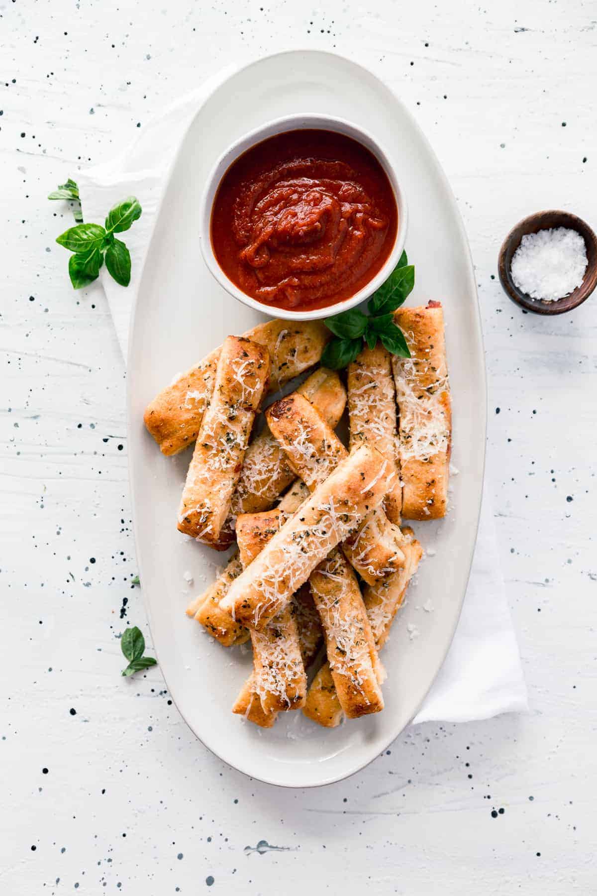 Easy cheesy pizza sticks are made with store-bought dough, pizza sauce, and cheese and only take 20 minutes to make, start to finish.